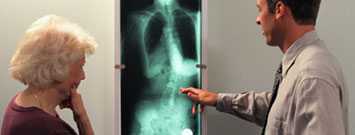 medical professional examing xray with patient