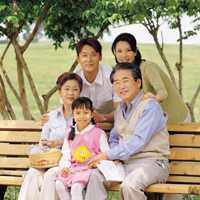 Photo: Family sitting on park bench