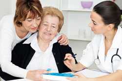 Senior mother and daughter consulting with healthcare worker