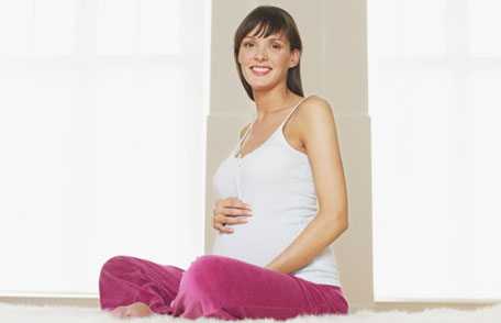 Pregnant woman sitting on floor