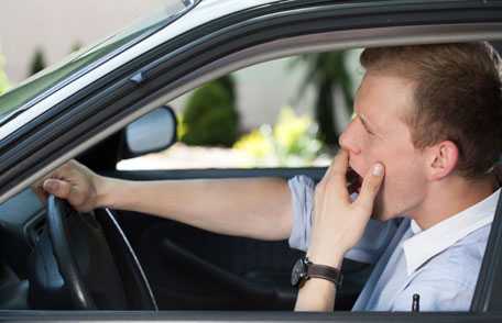 Man driving and yawning
