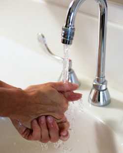 Someone washing hands in sink