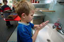 Young boy washing hands