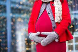 Pregnant woman wearing holiday clothes