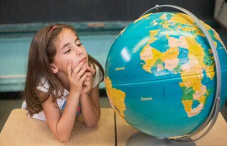 Girl looking at globe