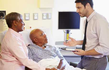 Doctor consulting with mature couple