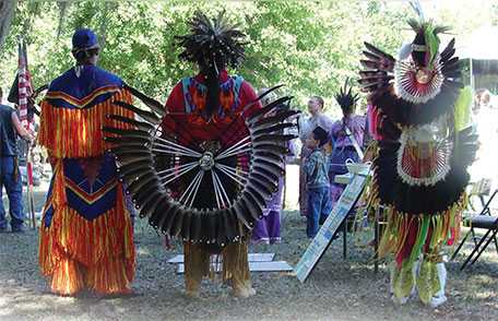 Native people dressed in traditional clothing observing National Native HIV/AIDS Awareness Day