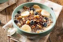 Bowl of cereal with blueberries and bananas