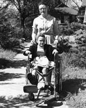 Historic photo of woman pushing child in wheelchair