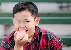 Boy eating fruit