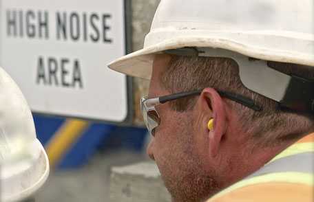 Construction working wearing ear protection gear