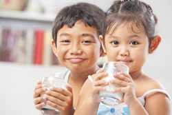 Two children drinking milk