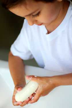 Boy washing hands with soap