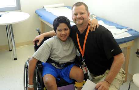 Boy with spina bifida with medical staff member