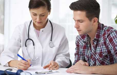 Photo: Female doctor consulting with male patient