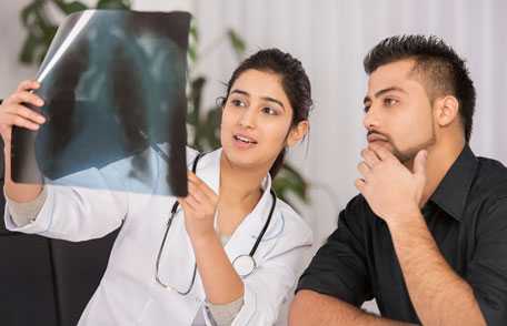 Doctor and patient looking at chest x-ray