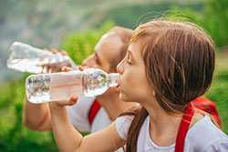 Young girl drinking bottled water
