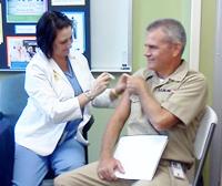 CEO, Dr. Greg Ketcher, being vaccinated.