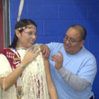 Public health nurse, Kendall Washburn, vaccinating Kiowa Tribal Princess, Antonia Belindo