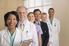 Photo of a group of health care professionals, men and women, working together.