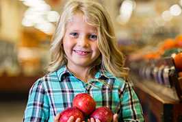 Little girl with apples istock 78305351
