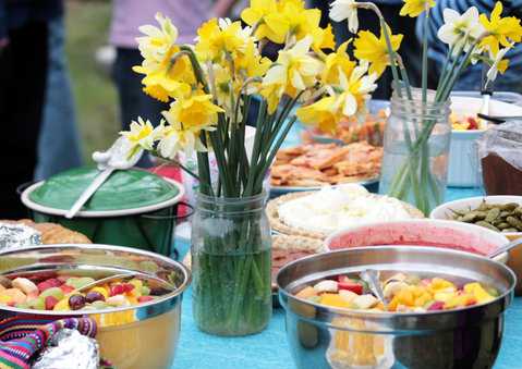 Picnic table with flowers and food
