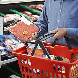 	Shopper selecting package meat.