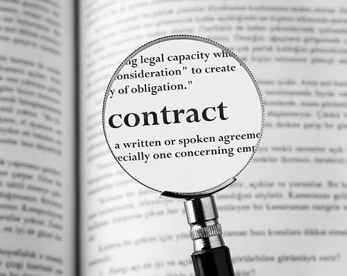 magnifyinmg glass over the word contract