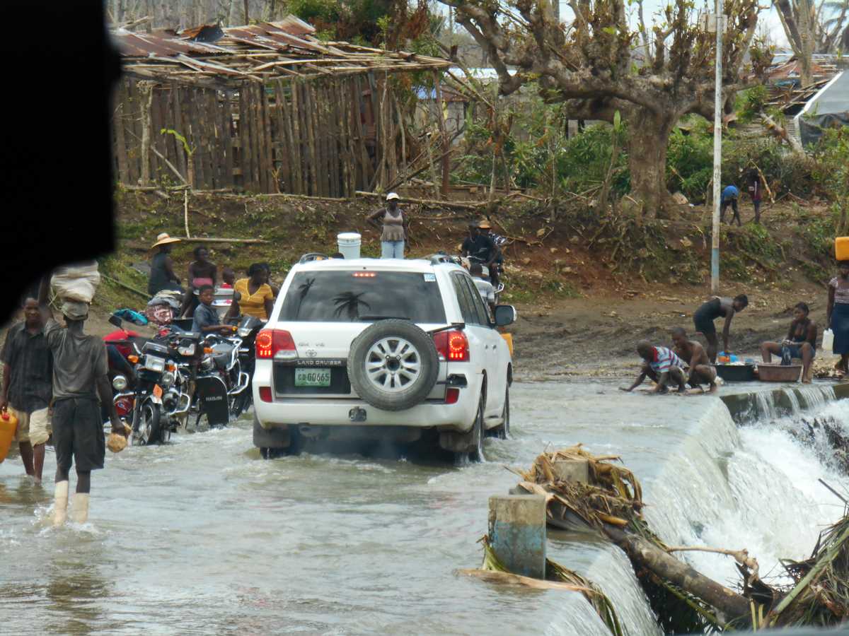 The cholera investigation team convoy crossing a river to get to a community