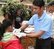 Image of a healthcare provider gives vaccines to children in a village