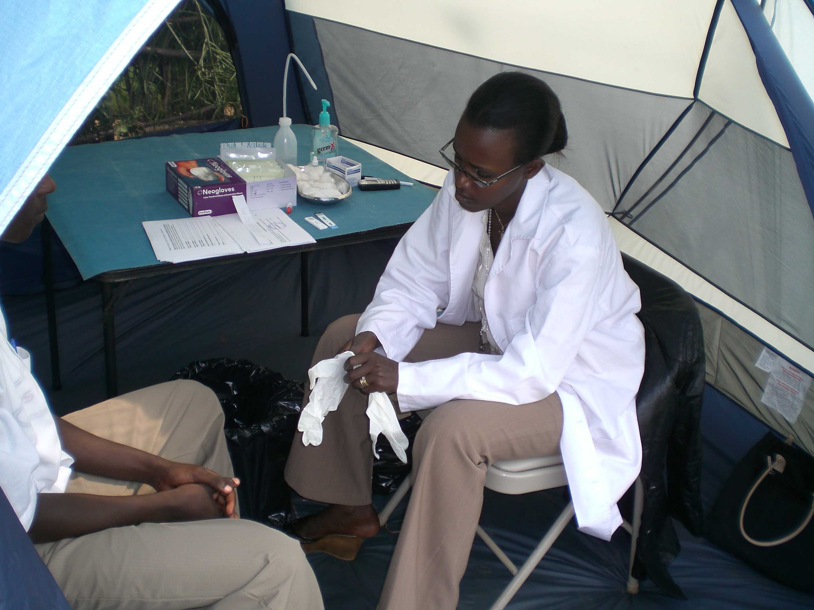CDC staffer preparing to give an HIV test using the finger prick method in a mobile VCT unit