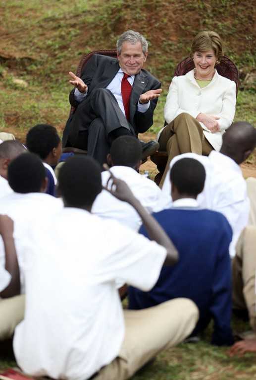 Photo of President Bush and the first lady as they talk with students of Lycee de Kigali High School’s ‘Anti-AIDS Club’