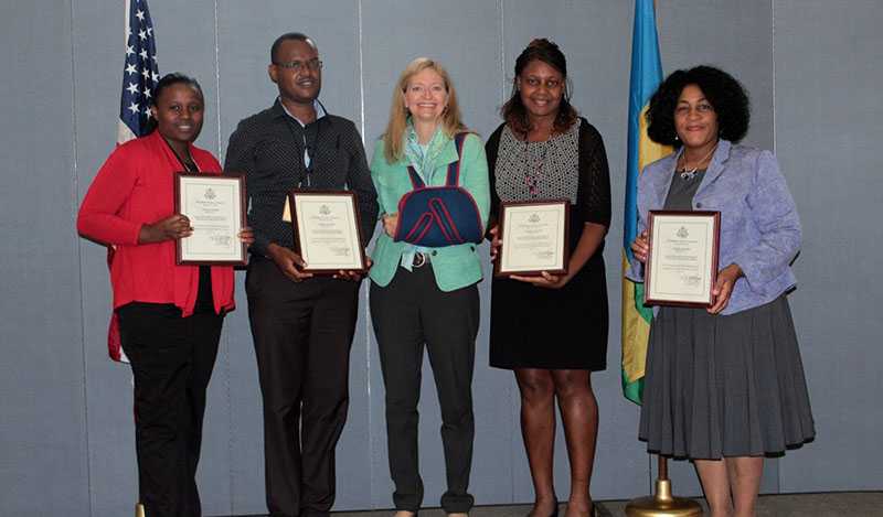 	CDC Rwanda staff Eugenie Murekatete, Antyme Kayisabe, Winifred King, and Pamela Gruduah receiving Eagle Awards from Ambassador Barks-Ruggles. (Photo: Courtesy of USG Mission Rwanda)