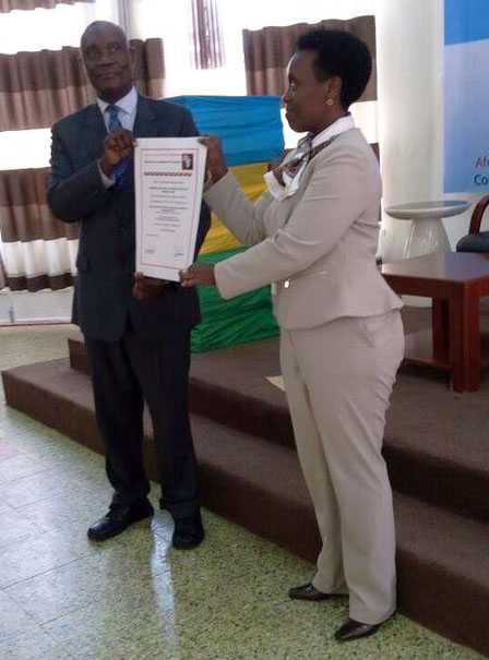 	Hon. Min. Dr. Gashumba receives the accreditation certificate from Dr. Muyinda of AfSBT.