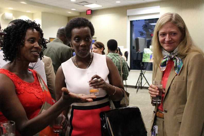 	Jacqueline explains one of the photos to Ambassador Barks-Ruggles and Hon. Minister Gashumba during the HIV partnership event. Photo Courtesy of W. Herkewitz/USAID Rwanda.
