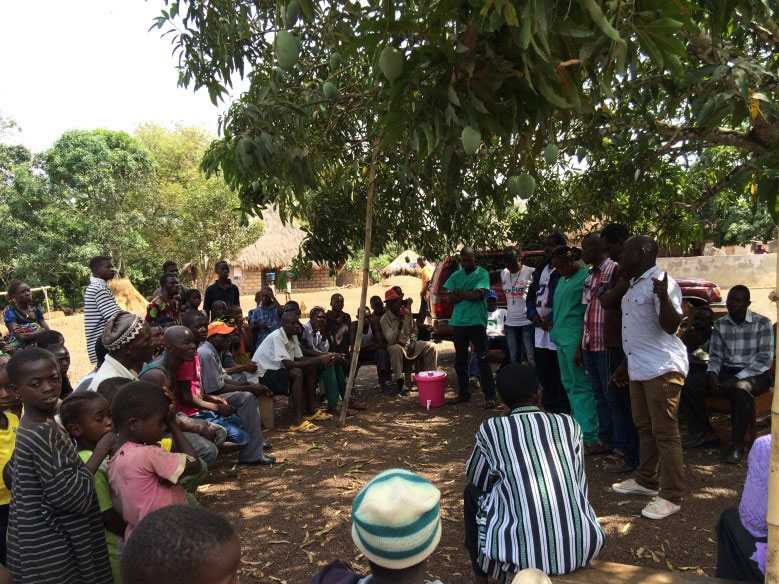 Team members of the Ambulance Project introducing themselves to the village Sanda Magbolontor. Along with explaining their role during the response (driver, decontamination sprayer, nurse, etc.), they also discussed stigma associated with their work in the Ebola response