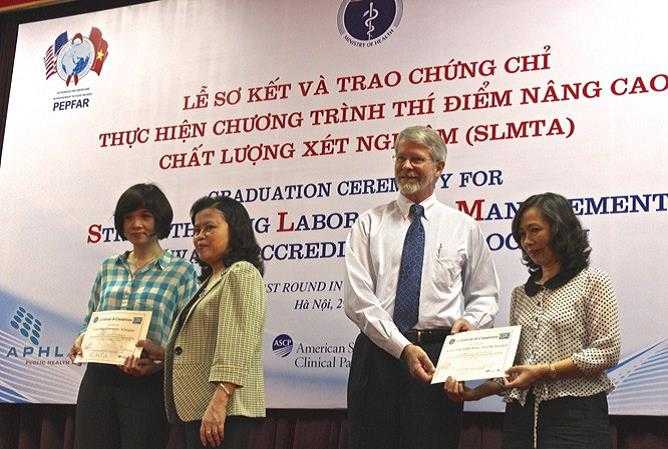 	David Nelson, CDC Vietnam Deputy Director and Vice Minister of Health Nguyen thi Xuyen giving certificates for SLMTA.