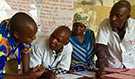 While reviewing maternal and newborn health records with a midwife (center) in Goma, DRC, she had to leave twice to deliver babies (Source: Alaine Knipes, CDC)