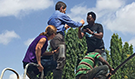 CDC Director Dr. Tom Frieden on top of a water tank in Tanzania with public health colleagues