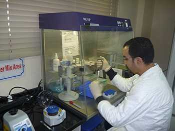 Scientist working in the Damanhur IEIP PCR laboratory unit.