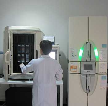 Scientist using the new laboratory system. It is a state-of-the-art, automated instrument used to classify bacteria and test their antibiotic susceptibilities at the same time, which is faster than conventional, manual methods.