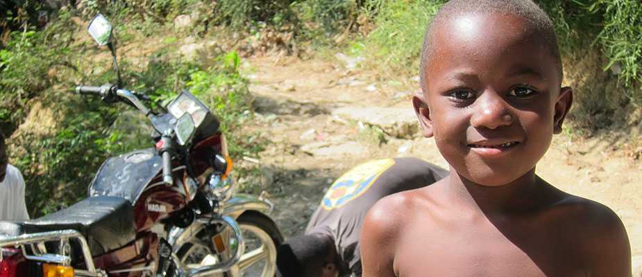 	A boy by a road in Haiti, where geographic information systems save lives and money for healthcare facilities (Source: CDC)