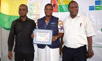 Placido Carsado (right), Director of the National Institute of Health, and Serifo Monteiro, Director of the National Public Health Laboratory, flanking Sabado Fernandes, an FETP-Frontline graduate in Guinea-Bissau. (Photo courtesy: Ken Johnson).