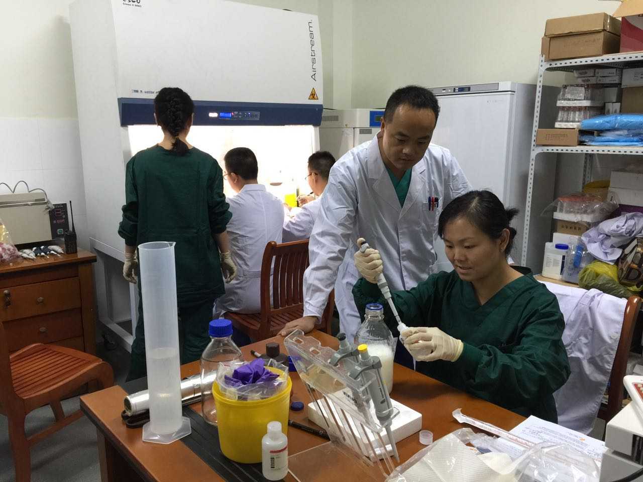 Yuzhi and ShuYu show laboratory staff how to perform the diagnostic test.