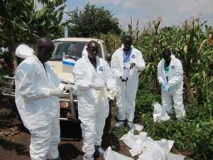 Health workers put on biohazard suits.
