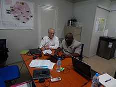 Dennis Jarvis (CDC NPHI Program) receives guidance from the Sierra Leone NPHA development lead, Dr. T.T. Samba.