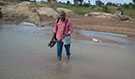 Nigeria FETP resident Dr. Wada Imam Bello carrying polio vaccine on foot across a river in Katsina, Nigeria
