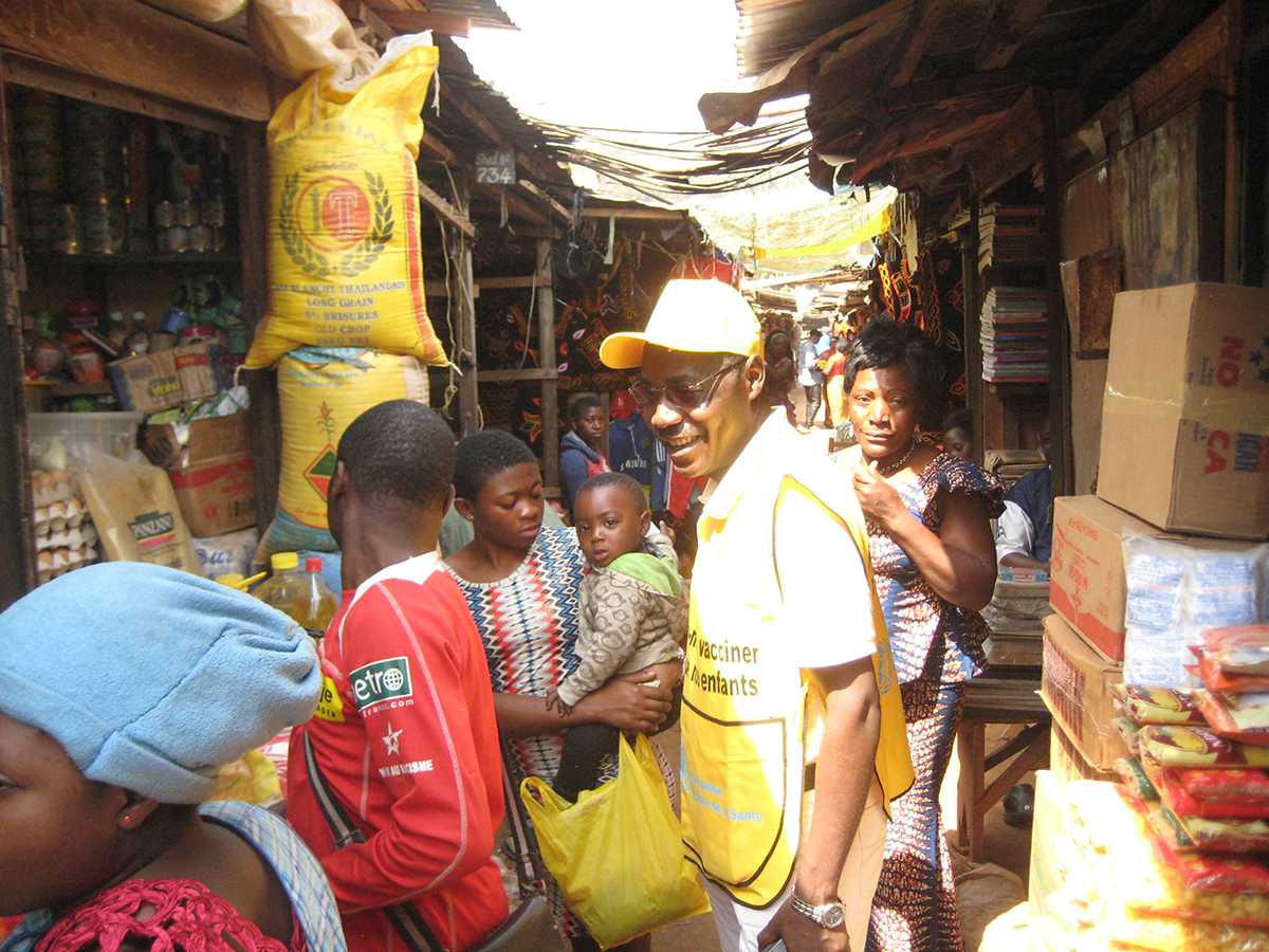 Cameroon: Vaccination teams in a market place promoting the polio campaign