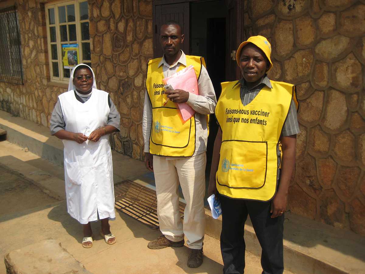 Cameroon: Members of the vaccination team (center and right) at a health center to vaccinate children. On the left is the director of the health facility. 