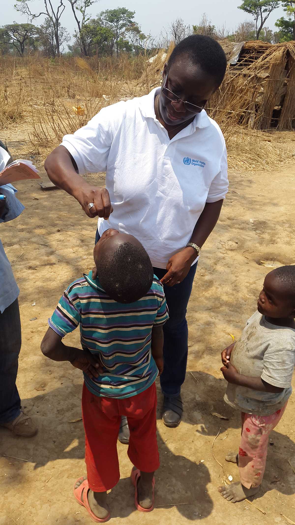 Democratic Republic of the Congo: Dr. Aissata Diaha from CDC’s Global Immunization Division administering the oral polio vaccine to a child during the polio immunization campaign in a remote area of Lubumbashi.
